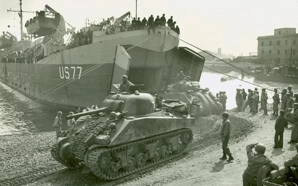 Military scene: M4 Sherman tank rolling off landing ship US77 onto a crowded dock, soldiers and civilians watching — 2K Quad HD PC Desktop Wallpaper and Background.