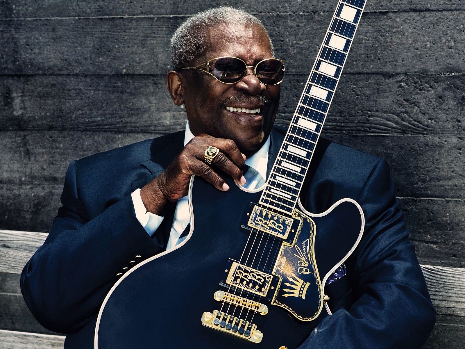 HD PC desktop wallpaper featuring blues legend BB King smiling and holding his iconic guitar, capturing the essence of music and soul.