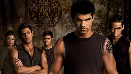 A dramatic scene from The Twilight Saga: New Moon, featuring a group of young men in dark clothing, exuding intensity against a textured, earthy background. HD desktop wallpaper.