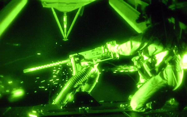 A high-definition desktop wallpaper featuring a soldier operating a machine gun, captured in green night vision, showcasing the intensity of a tactical situation.