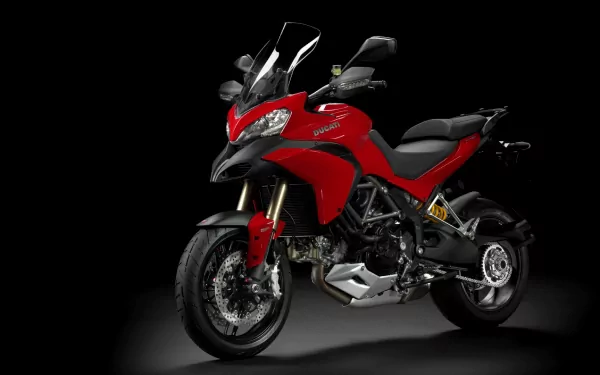 HD desktop wallpaper featuring a red Ducati motorcycle against a black background, showcasing the vehicle's sleek design and detailed craftsmanship.