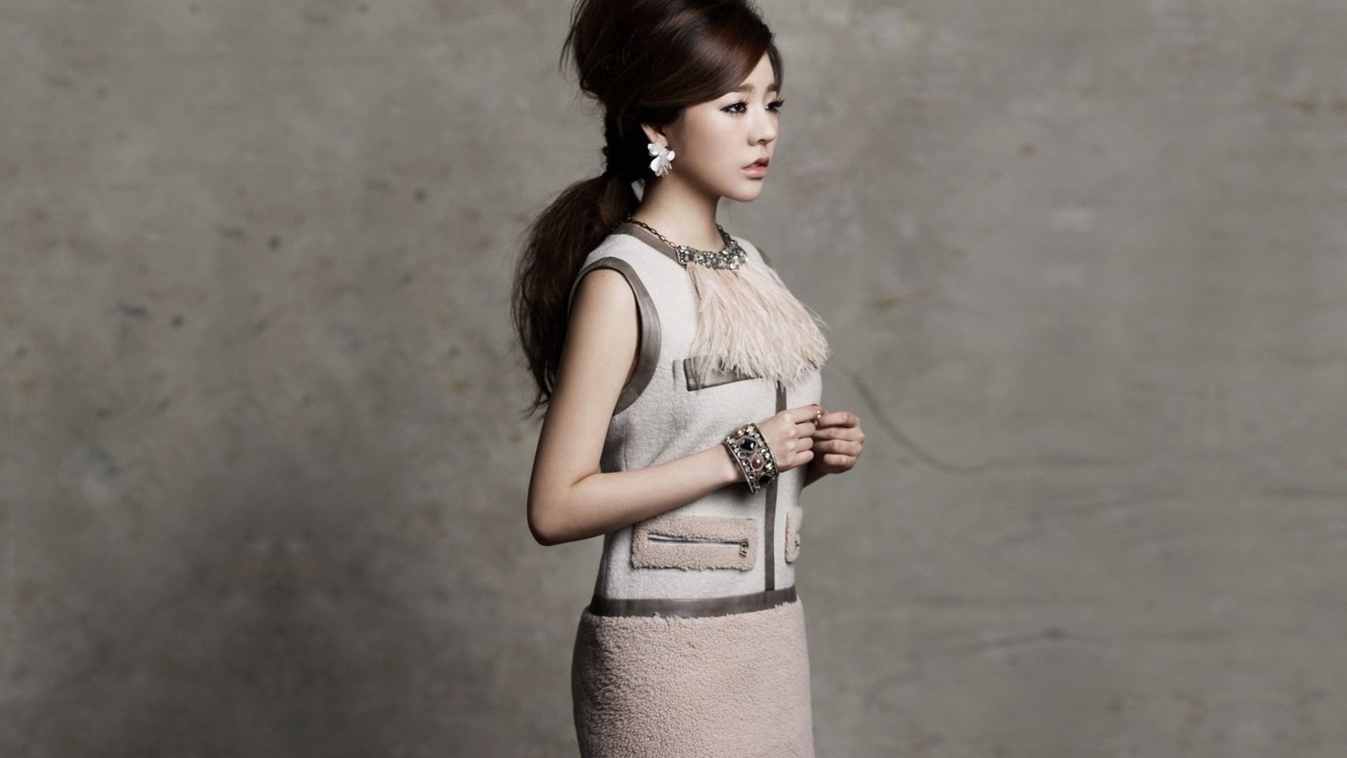 A side profile of an Asian woman in an elegant outfit against a textured gray background. This HD image serves as a stylish desktop wallpaper.