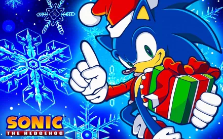 HD PC desktop wallpaper featuring Sonic the Hedgehog in a Santa hat holding a wrapped gift, set against a vibrant blue background with large snowflakes.