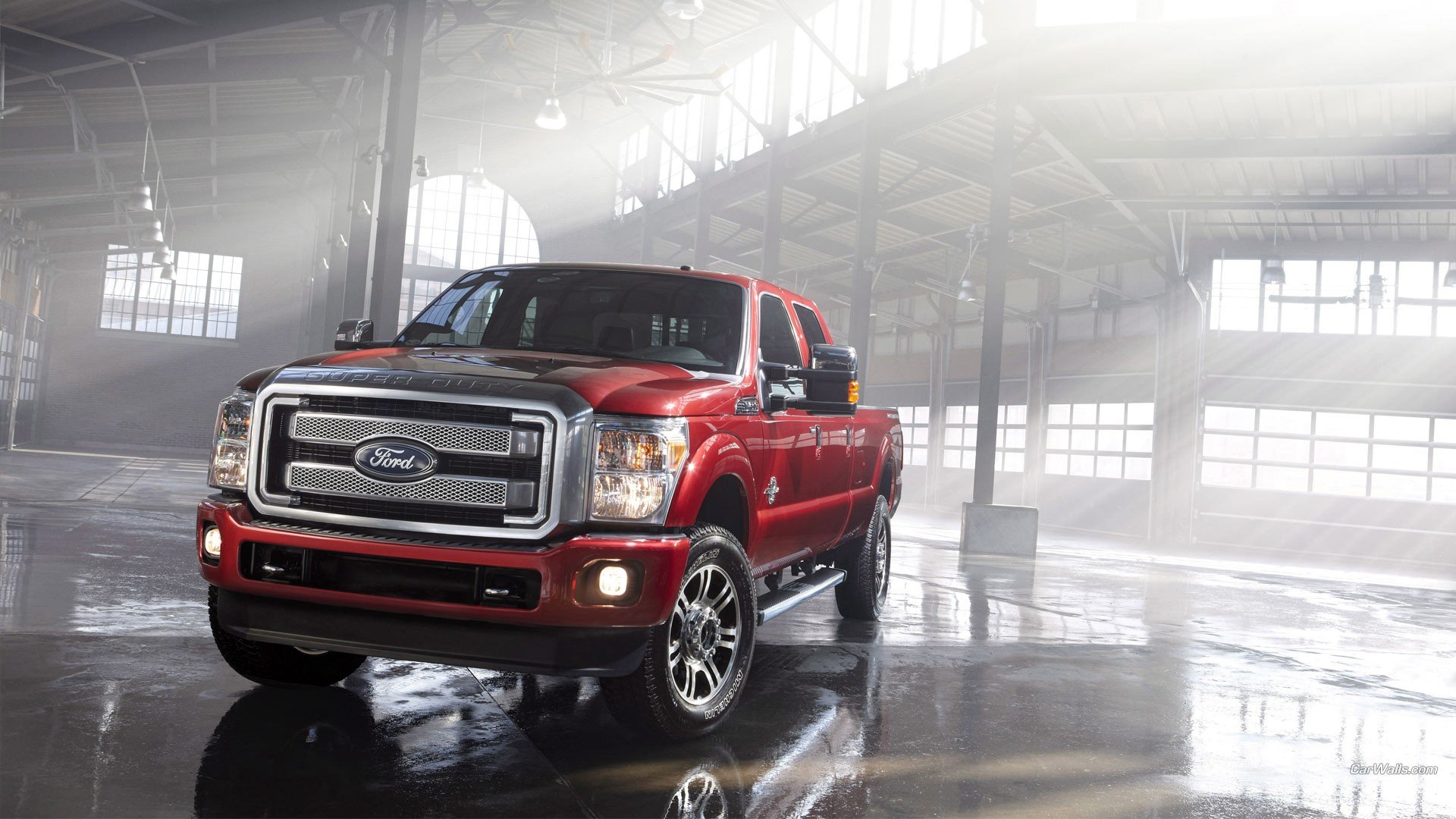 HD PC desktop wallpaper of a red Ford Super Duty Platinum pickup vehicle parked in a misty industrial warehouse, glossy floor reflecting the truck.