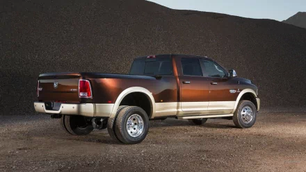 HD desktop wallpaper of a Dodge Ram 3500 vehicle parked on a gravel surface with a natural hillside backdrop.