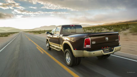 HD PC desktop wallpaper/background of a vehicle — a brown Dodge Ram 3500 pickup driving down an empty highway at sunset.