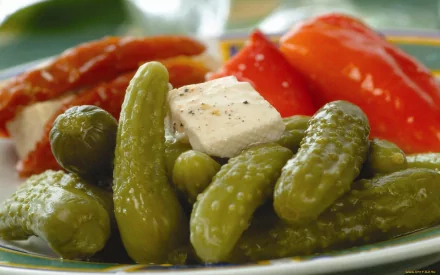 HD PC desktop wallpaper featuring a close-up of fresh cucumbers with a piece of white cheese and red peppers, highlighting vibrant food textures.