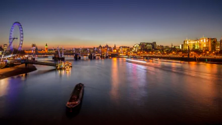 HD desktop wallpaper of a sunset view over the River Thames in London, featuring the London Eye and city lights reflecting on the water.