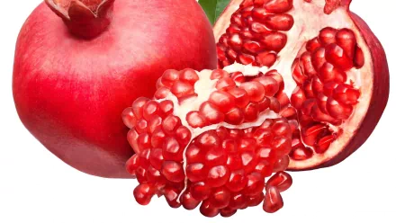 HD PC desktop wallpaper featuring a vibrant close-up of a whole and a split-open pomegranate with glistening red seeds against a plain background.