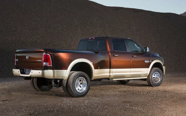 HD desktop wallpaper of a Dodge Ram 3500 vehicle parked on a gravel surface with a natural hillside backdrop.