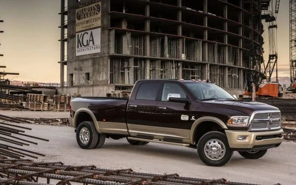 HD PC desktop wallpaper/background of a vehicle: a Dodge Ram 3500 crew cab pickup parked among steel beams in front of an unfinished construction building.