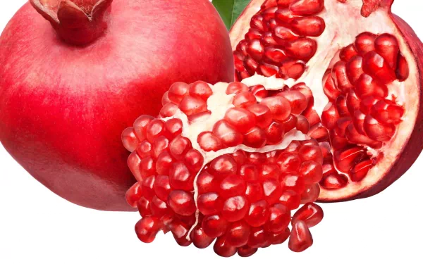 HD PC desktop wallpaper featuring a vibrant close-up of a whole and a split-open pomegranate with glistening red seeds against a plain background.