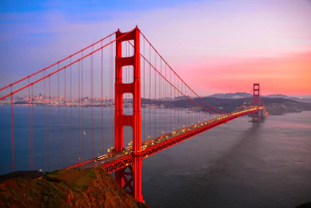 HD wallpaper of the Golden Gate Bridge in San Francisco at sunset, showcasing vibrant sky colors and cityscape in the background.