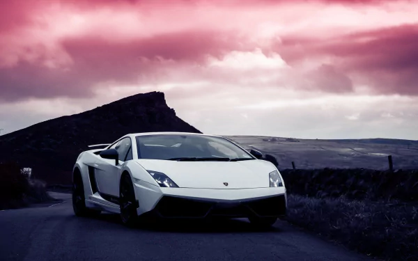HD PC desktop wallpaper featuring a white Lamborghini Gallardo Superleggera parked on a scenic road with a dramatic pink and purple sky backdrop.