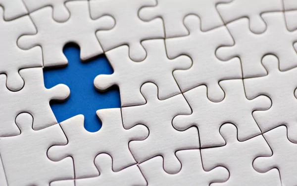 HD wallpaper featuring a close-up of a puzzle with one piece missing, revealing a blue background.