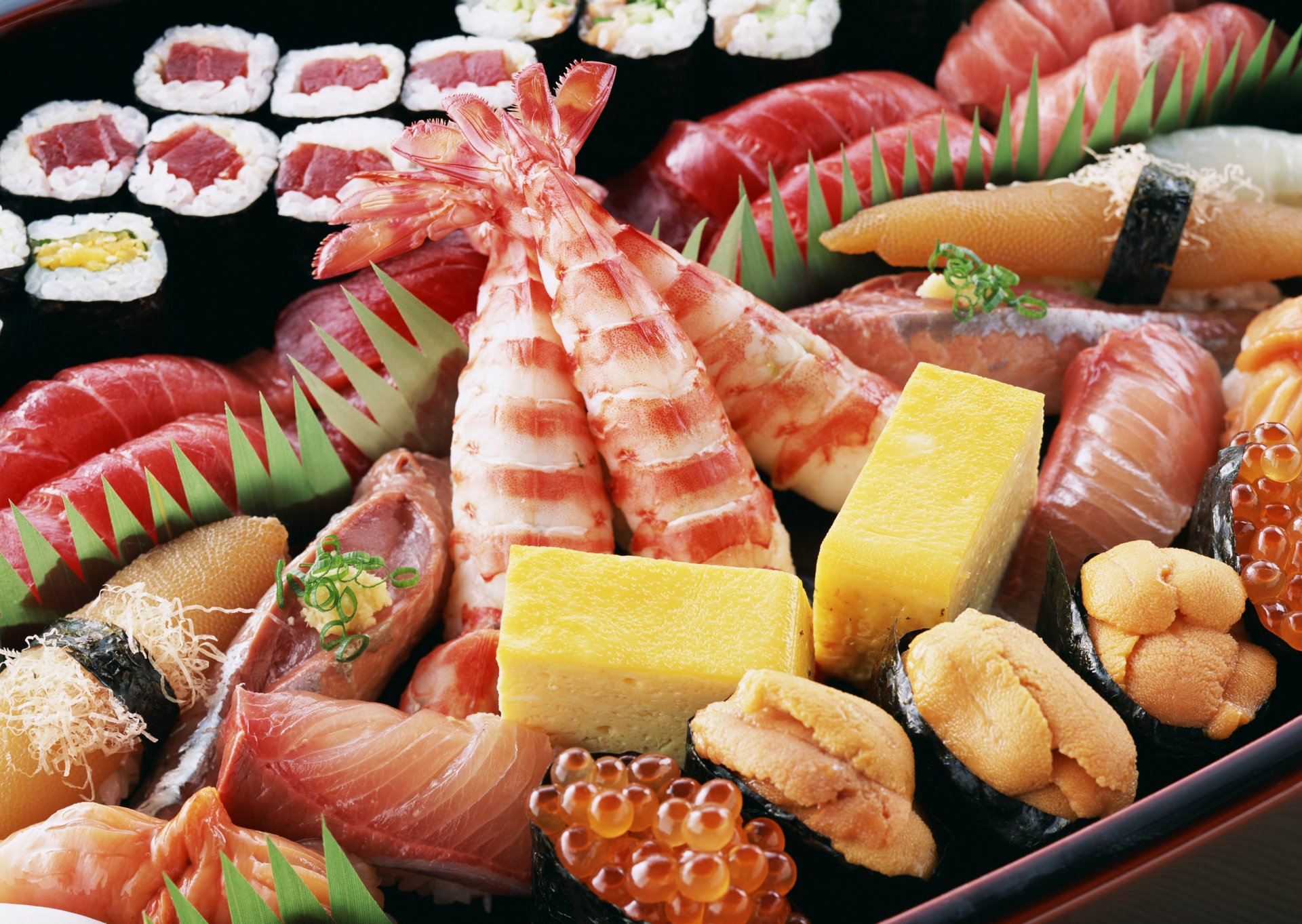 HD PC desktop wallpaper featuring a vibrant assortment of fresh seafood sushi and sashimi arranged artistically on a black platter.