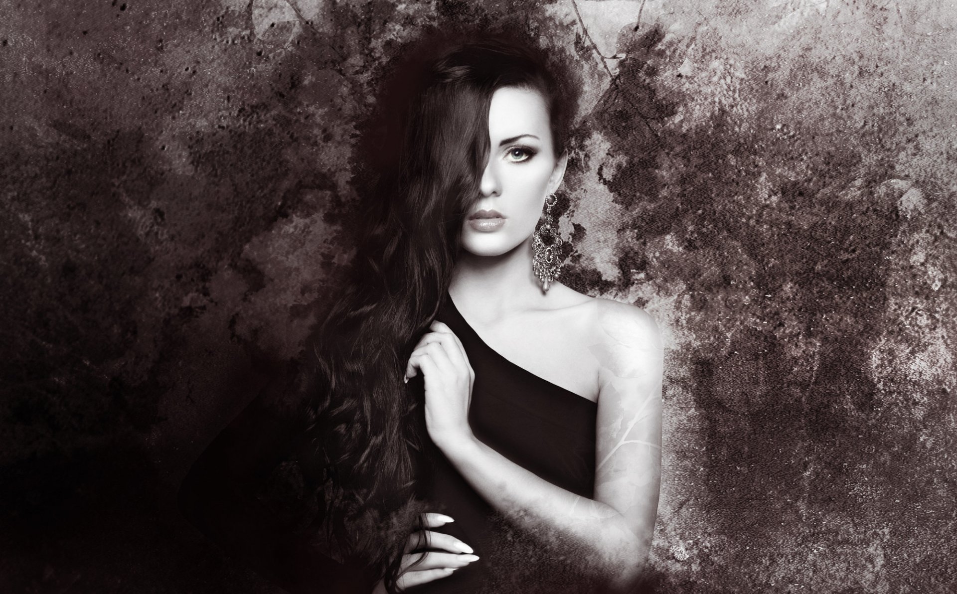 Artistic HD wallpaper featuring a woman with long hair, posed against a textured background, exuding a captivating and moody atmosphere.