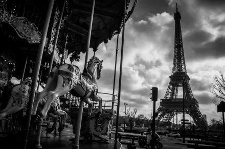 A black and white image of a carousel horse in Paris, with the Eiffel Tower looming in the background, captured in stunning 4K Ultra HD detail.