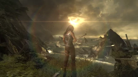 HD PC desktop wallpaper featuring Lara Croft from the Tomb Raider video game, standing on a cliff overlooking a dramatic, cloudy landscape at sunset.