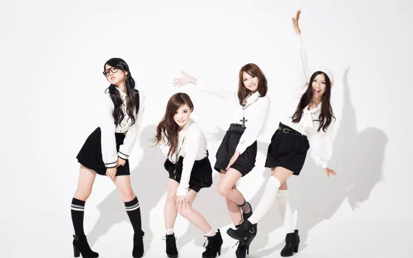 HD PC desktop wallpaper of four women in black-and-white outfits striking energetic poses—music-themed, with a bold 'Scandal' pop vibe.
