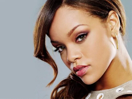 A striking HD wallpaper featuring Rihanna, showcasing her captivating expression and style, perfectly complementing any music lover's desktop background.
