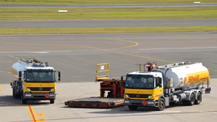 HD desktop wallpaper showing two Mercedes-Benz Shell VIP jet tanker vehicles parked on an airport tarmac.