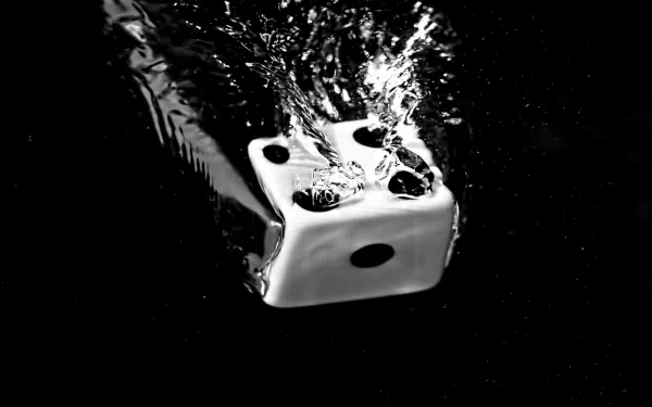A high-definition desktop wallpaper featuring a white die sinking into water, creating dynamic splashes against a dark background, emphasizing a captivating contrast.