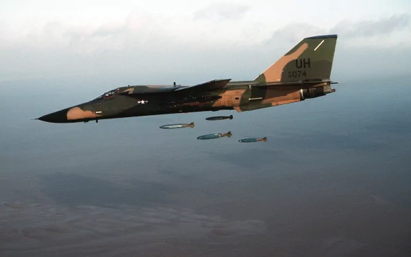 An HD desktop wallpaper featuring a military General Dynamics F-111 Aardvark jet in flight, dropping precision bombs against a backdrop of blue skies.