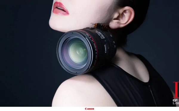 A striking HD wallpaper featuring a close-up of a woman's neck and shoulder, adorned with a Canon camera lens, blending elements of fashion and photography artistry.