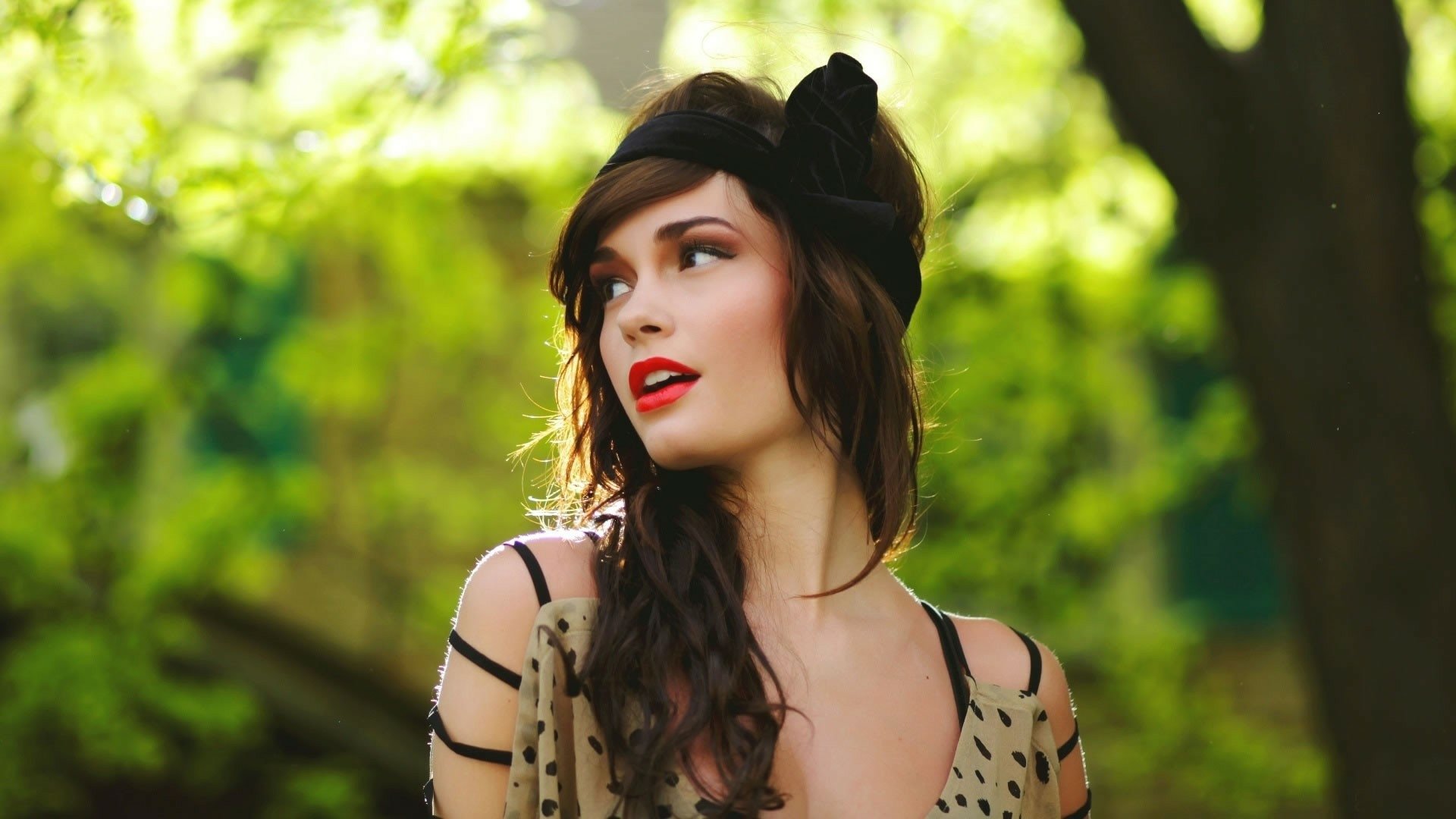 HD PC desktop wallpaper featuring Casey Carlson in a music-inspired portrait with a soft-focus green natural background.