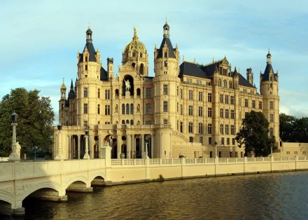 A stunning view of Schwerin Palace, showcasing its intricate architecture reflected in the surrounding water, designed as a 4K Ultra HD PC desktop wallpaper and background.