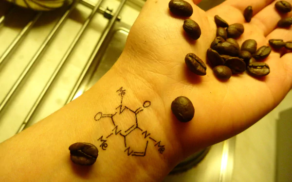 A hand with coffee beans and a drawn molecule represents the connection between coffee, science, and technology in physics and chemistry. 4K Ultra HD wallpaper background.