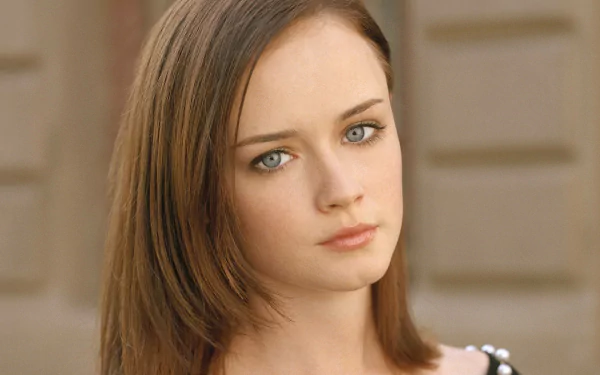 A close-up image of Alexis Bledel, featuring her striking blue eyes and smooth brown hair, set against a softly blurred background, designed as an HD desktop wallpaper.