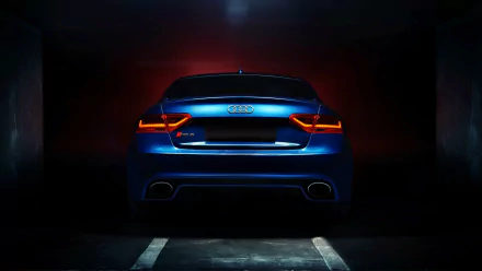A striking HD wallpaper featuring an Audi RS6 showcased from the rear, illuminated by dramatic lighting, with an Audi RS5 subtly suggested in the background.