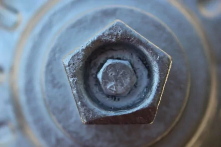 Close-up of a textured bolt captured as a high-definition desktop wallpaper background.