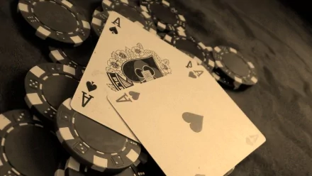 Close-up of playing cards and poker chips arranged together, showcasing a high-definition desktop wallpaper with a man-made card theme.