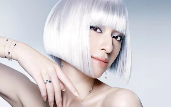 HD PC desktop wallpaper featuring a close-up portrait of woman Chiaki Kuriyama with a sleek white bob hairstyle and delicate jewelry against a light background.