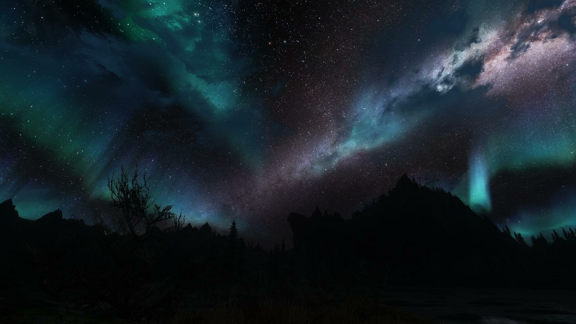 HD PC desktop wallpaper featuring a night sky with Northern Lights over a dark mountainous landscape from the video game The Elder Scrolls V: Skyrim.
