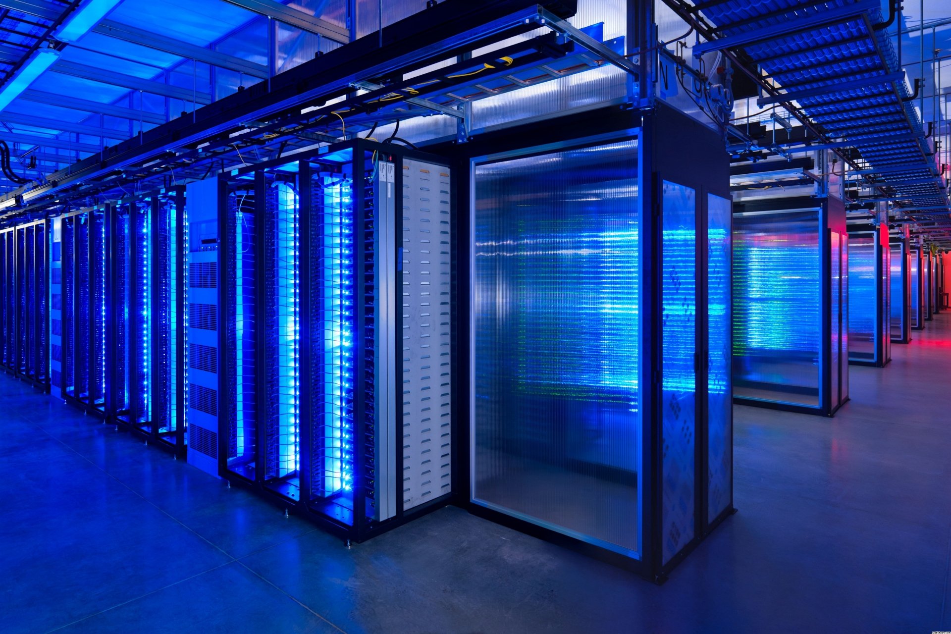 HD desktop wallpaper featuring a modern server room with rows of illuminated data cabinets in blue and red lights.