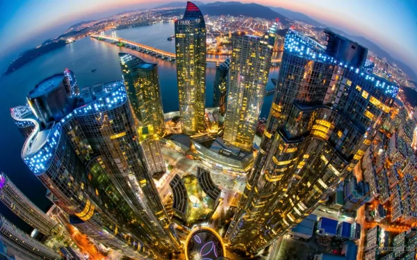 A vibrant, man-made cityscape of Busan at night, captured in high definition for a dynamic PC desktop wallpaper and background.