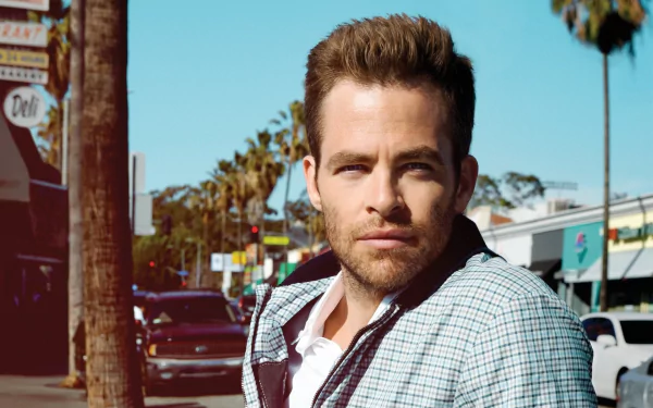 HD PC desktop wallpaper featuring celebrity Chris Pine with a confident expression against a sunny urban street backdrop with palm trees.