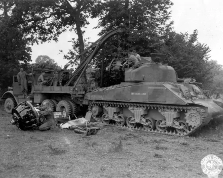 Black and white HD desktop wallpaper featuring a military M4 Sherman tank undergoing maintenance in a wooded outdoor setting.