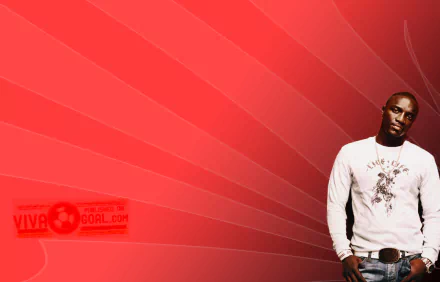 HD PC desktop wallpaper: music-themed portrait of a male singer in a white shirt standing at right against a red radiating gradient background.