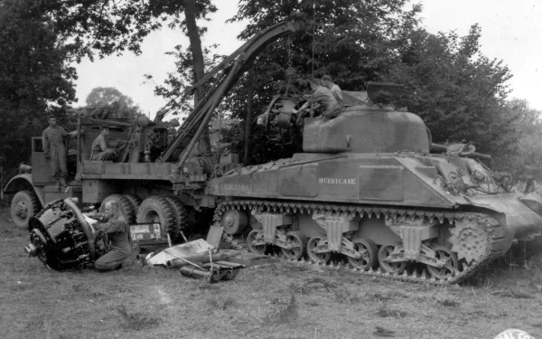 Black and white HD desktop wallpaper featuring a military M4 Sherman tank undergoing maintenance in a wooded outdoor setting.