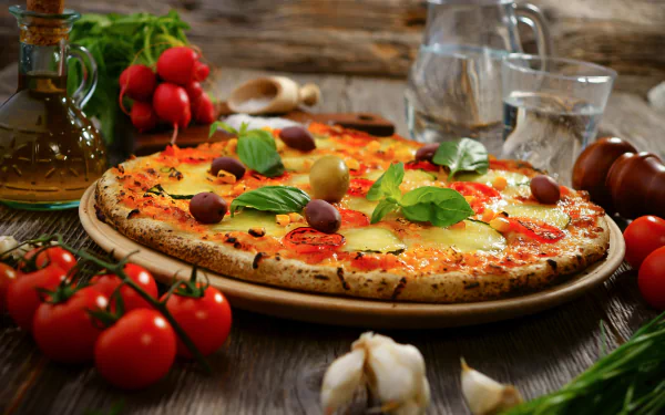 A vibrant pizza topped with fresh herbs, olives, and tomatoes, set against a rustic wooden background, creating a delicious and inviting food-themed HD desktop wallpaper.