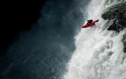 HD desktop wallpaper of a kayaker navigating powerful whitewater rapids, capturing the intensity and thrill of the sport.