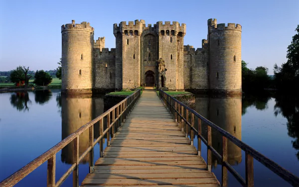 HD PC desktop wallpaper featuring the man-made Bodiam Castle reflected in the surrounding moat under a clear blue sky.
