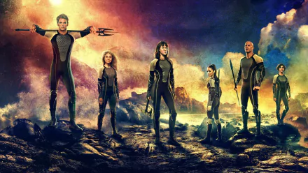 HD desktop wallpaper featuring the cast of The Hunger Games: Catching Fire, standing in a dramatic, fiery landscape from the movie.