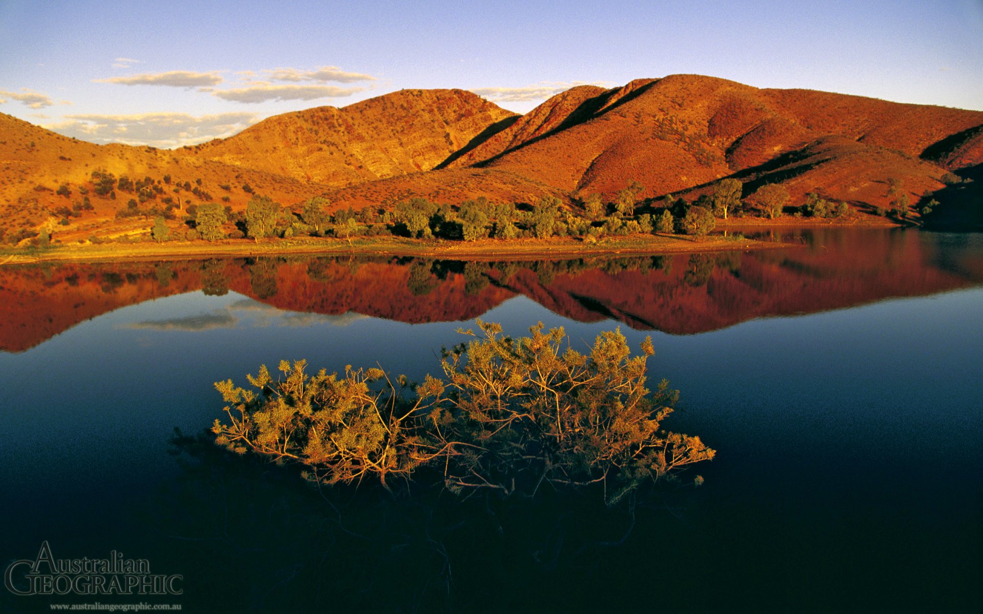 HD desktop wallpaper showcasing the serene natural beauty of Flinders Ranges with reddish hills reflected in a calm body of water under a clear sky.