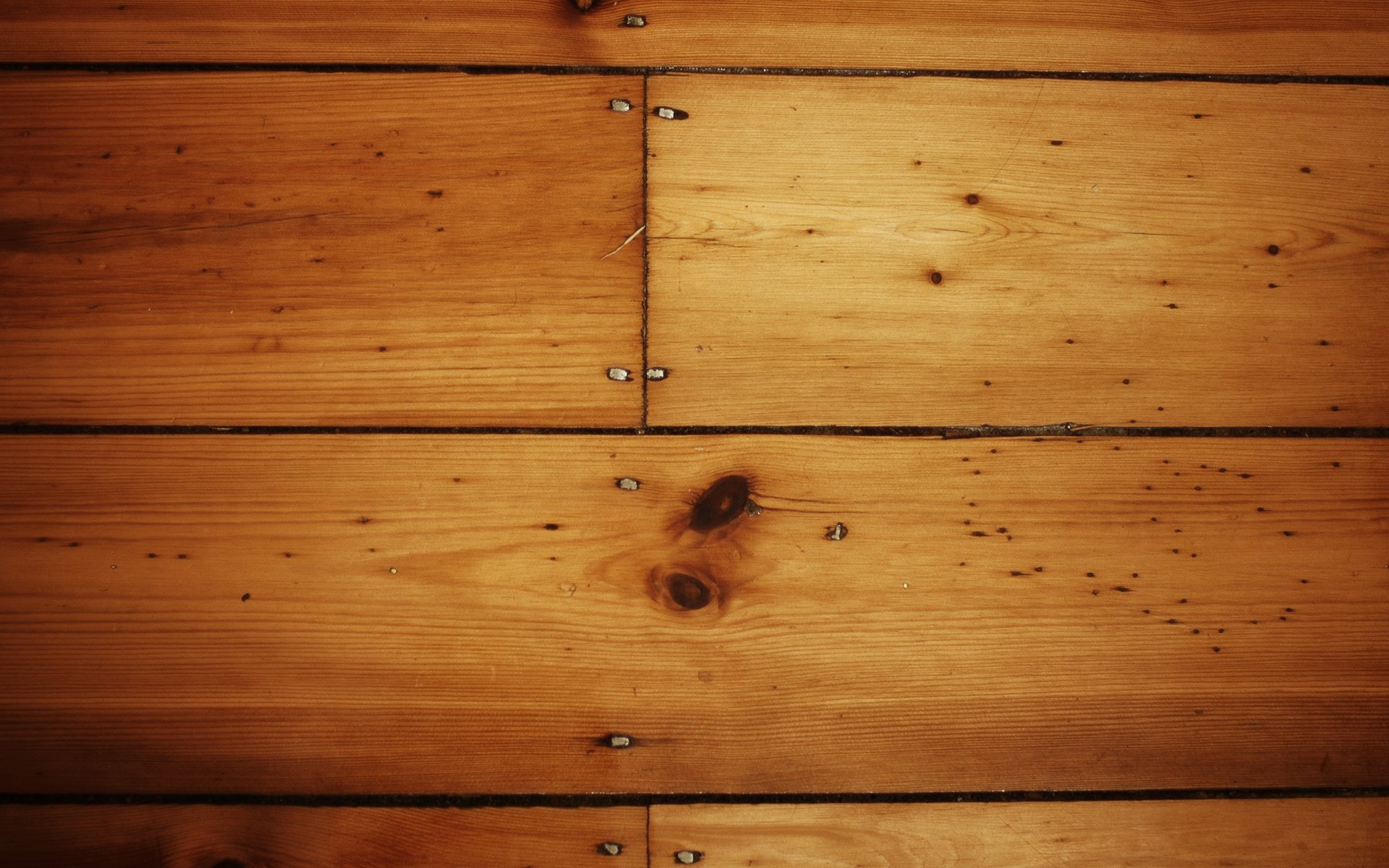 A close-up view of wooden planks showcasing rich textures and natural knots, serving as an artistic HD wallpaper and background for PC desktops.